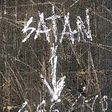 About God and the world "Satan" - inscription on one of the towers of Cologne Cathedral