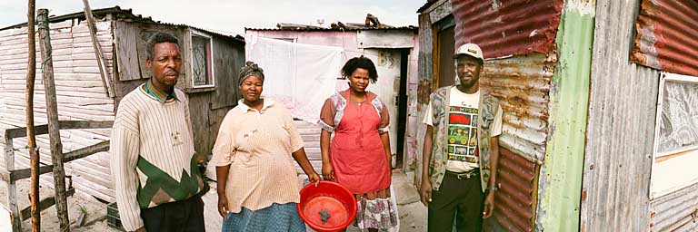 Khayelitsha - Bewohner vor ihren Hütten